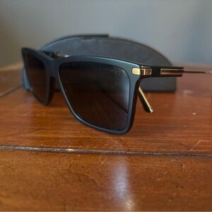 Prada - Matte Black Sunglasses with Gold Accents